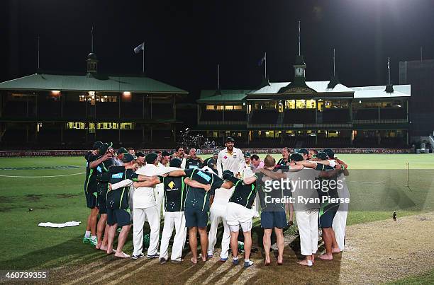 Nathan Lyon of Australia leads the team song on the pitch at midnight after day three of the Fifth Ashes Test match between Australia and England at...