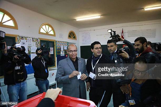 Tunisian presidential candidate Moncef Marzouki casts his vote at Sidi el Kantaoui school during the second round of Tunisia's presidential election...