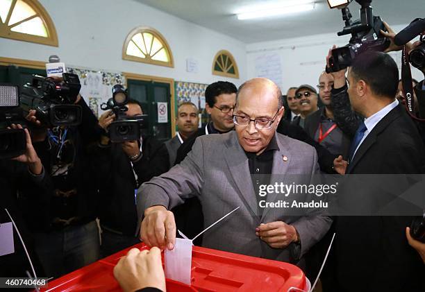 Tunisian presidential candidate Moncef Marzouki casts his vote at Sidi el Kantaoui school during the second round of Tunisia's presidential election...