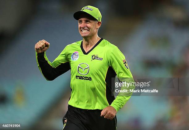 Mike Hussey of the Thunder celebrates the wicket of Andrew Flintoff of the Heat during the Big Bash League match between the Sydney Thunder and...