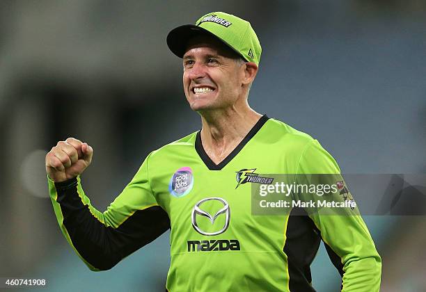 Mike Hussey of the Thunder celebrates the wicket of Andrew Flintoff of the Heat during the Big Bash League match between the Sydney Thunder and...