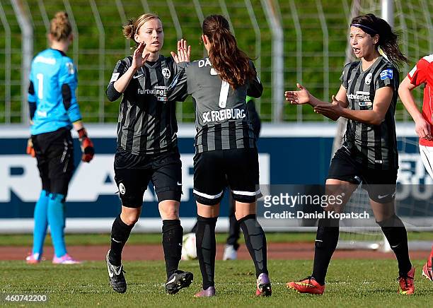 Juliane Maier of Freiburg celebrates her team's second goal with team mates Sara Daebritz and Sylvia Arnold during the Women's DFB Cup Quarter Final...