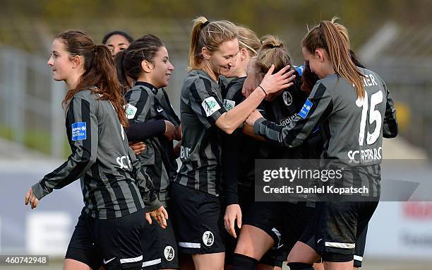 Lena Petermann of Freiburg celebrates her team's fith goal with team mates during the Women's DFB Cup Quarter Final match between SC Freiburg and FSV...