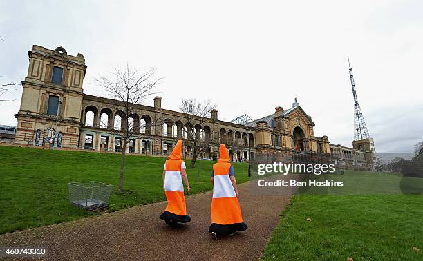 Spectators dressed as traffic cones make their way to the venue on day four of the 2015 William Hill PDC World Darts Championships at Alexandra...