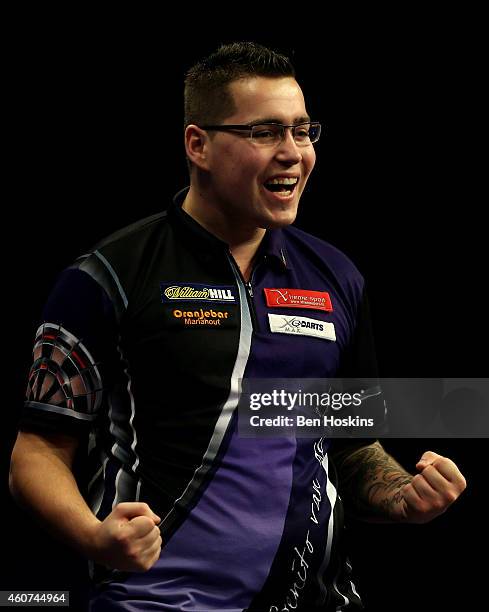 Benito van de Pas of the Netherlands celebrates winning his first round match against Paul Nicholson of England on day four of the 2015 William Hill...