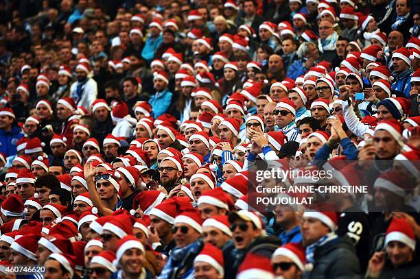 Marseille's supporters wear Santa Claus bonnets as they attend the French L1 football match Marseille vs Lille on December 21, 2014 at the Velodrome...