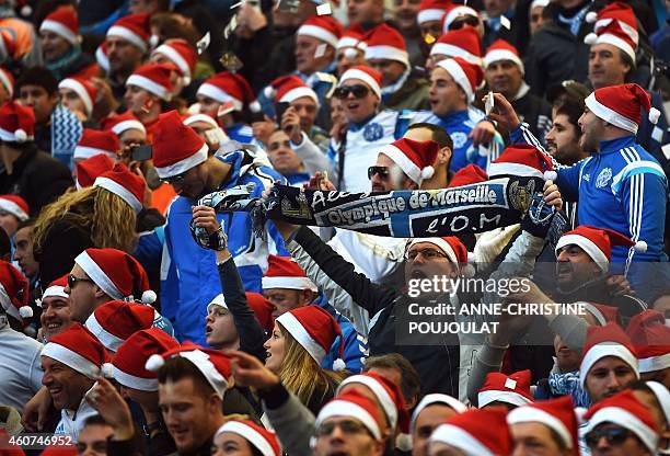 Marseille's wearing Santa Claus bonnets attend the French L1 football match Marseille vs Lille on December 21, 2014 at the Velodrome stadium in...