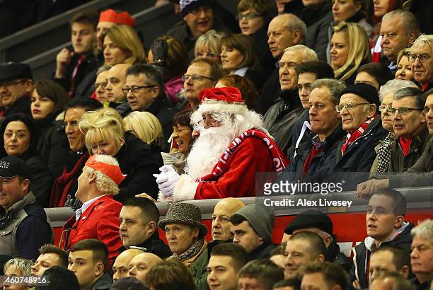 Fan dressed as Father Christmas watches the Barclays Premier League match between Liverpool and Arsenal at Anfield on December 21, 2014 in Liverpool,...