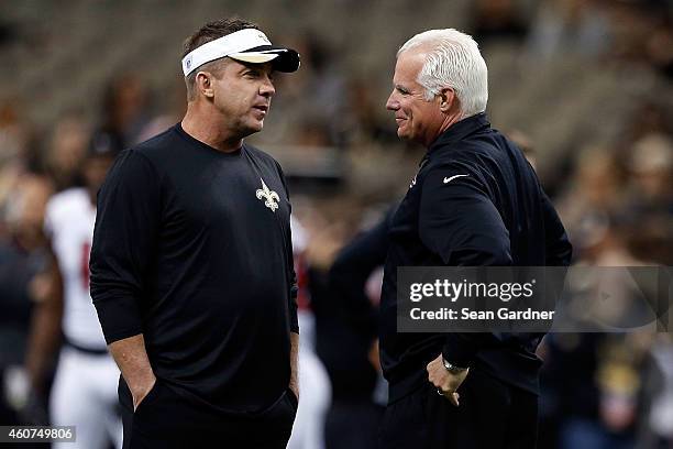 Head coach Sean Payton of the New Orleans Saints greets head coach Mike Smith of the Atlanta Falcons at midfield prior to a game at the Mercedes-Benz...