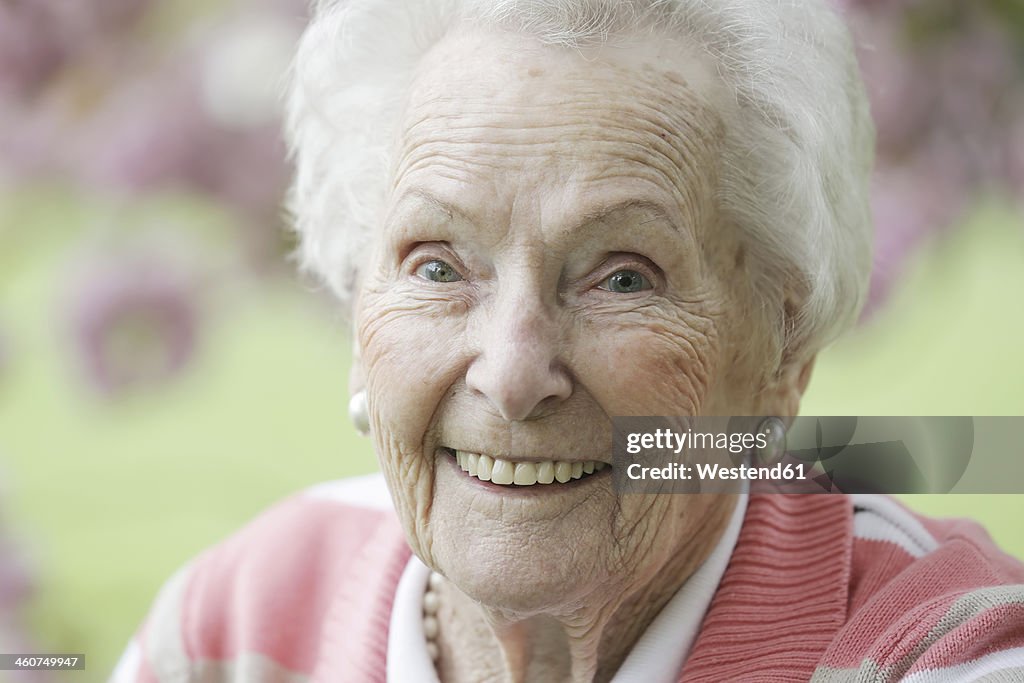 Germany, Cologne, Portrait of senior woman smiling, close up