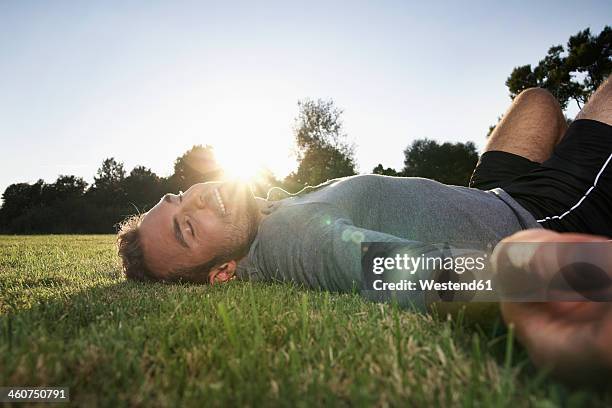 germany, cologne, - lying on grass stock-fotos und bilder