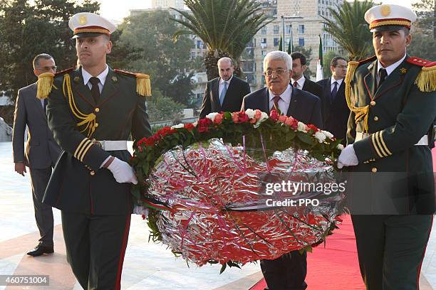 In this handout photo provided by the Palestinian Press Office , Palestinian President, Mahmoud Abbas lays a wreath at the tomb of the Unknown...