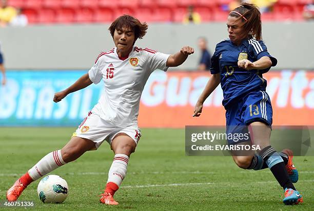 China's player Wang Shuang vies for the ball with Argentina's player Camila Gomez during their Brasilia International Tournament football 3rd place...