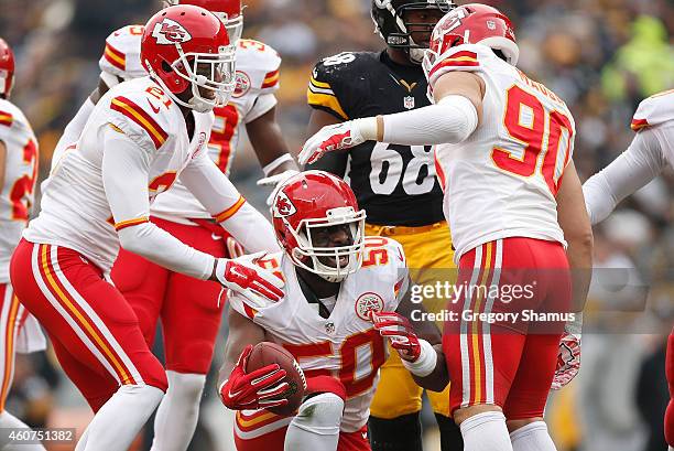Justin Houston celebrates his fumble recovery with Sean Smith and Josh Mauga of the Kansas City Chiefs during the second quarter against the...