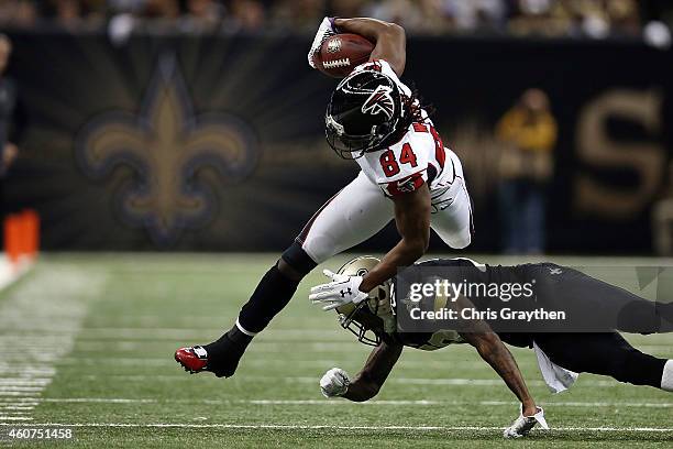 Roddy White of the Atlanta Falcons is brought down by Keenan Lewis of the New Orleans Saints during the second quarter of a game at the Mercedes-Benz...