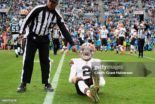 Johnny Manziel of the Cleveland Browns reacts after being hit by Luke Kuechly of the Carolina Panthers during their game at Bank of America Stadium...