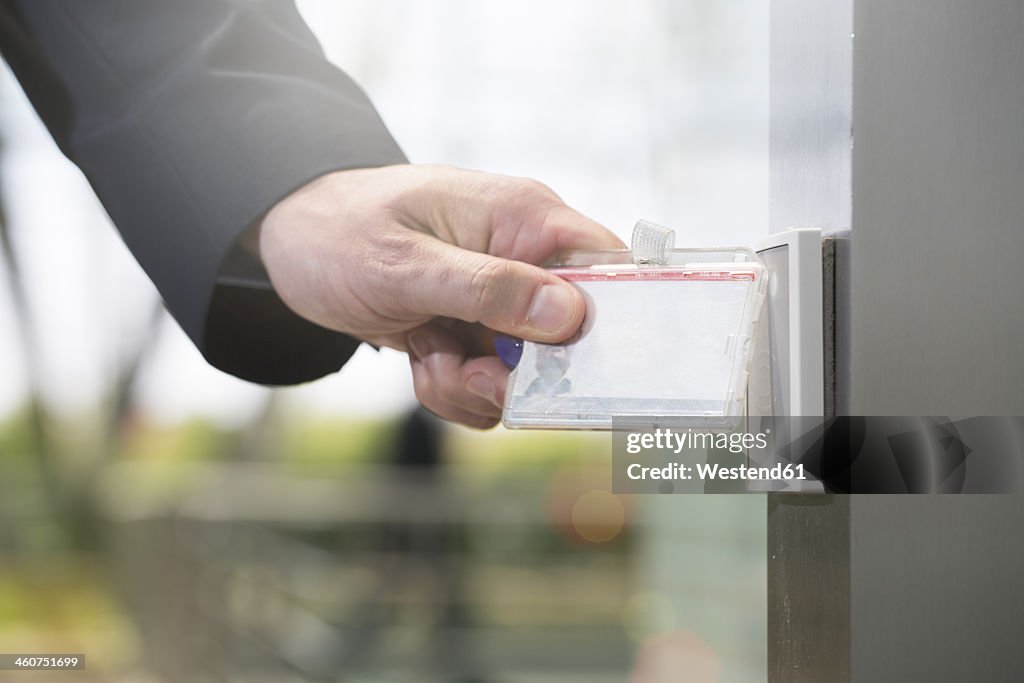 Germany, Hannover, Businessman using access card, close up