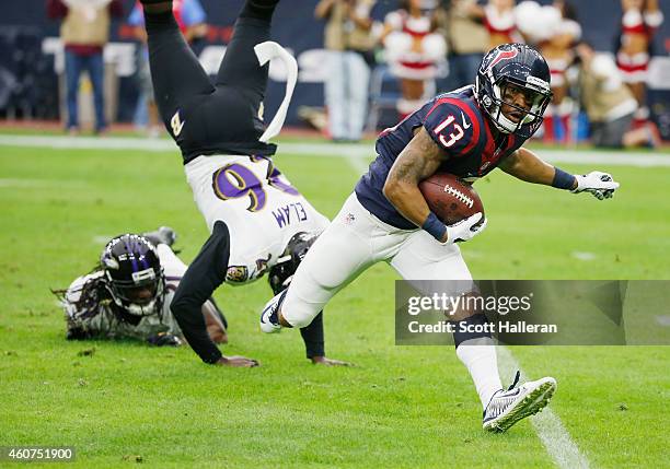 Damaris Johnson of the Houston Texans runs with the ball in front of Matt Elam of the Baltimore Ravens during the game at NRG Stadium on December 21,...