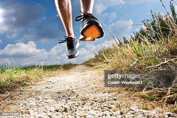 germany, bavaria, mature man jogging - schoenzool stockfoto's en -beelden