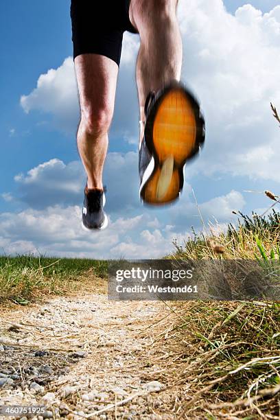 germany, bavaria, mature man jogging - sole of shoe stock-fotos und bilder