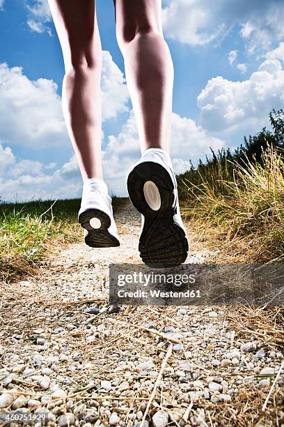 germany, bavaria, mature woman jogging - sole of shoe stock-fotos und bilder