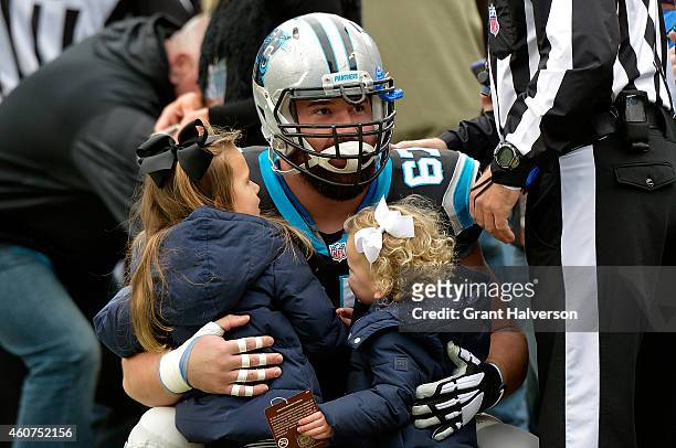 Ryan Kalil of the Carolina Panthers says hello to some young fans before the game against the Cleveland Browns at Bank of America Stadium on December...