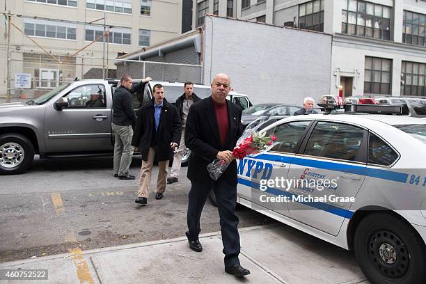 Secretary of Homeland Security Jeh Johnson arrives with a bouquet of flowers to speak with officers at the New York Police Department 84th Precinct...