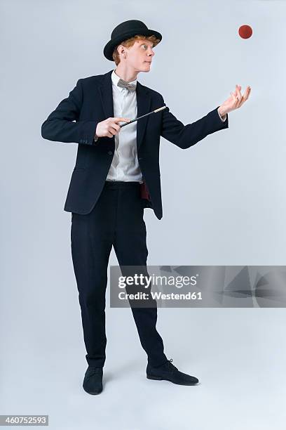 young man showing magic with ball - goochelaar stockfoto's en -beelden