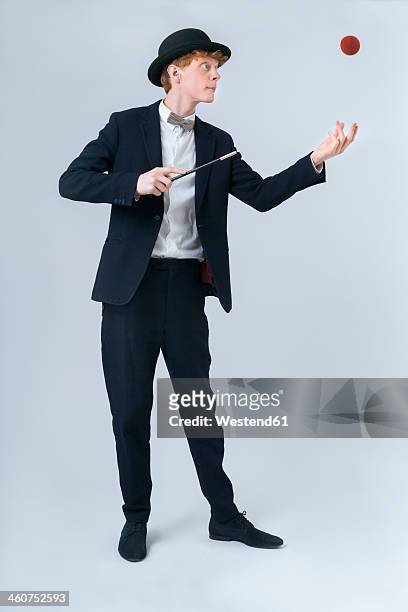 young man showing magic with ball - magician stock pictures, royalty-free photos & images