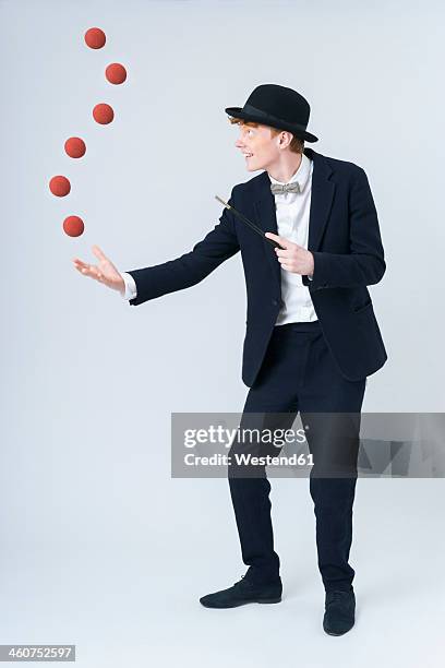 young man showing magic with ball, smiling - juggling stock pictures, royalty-free photos & images