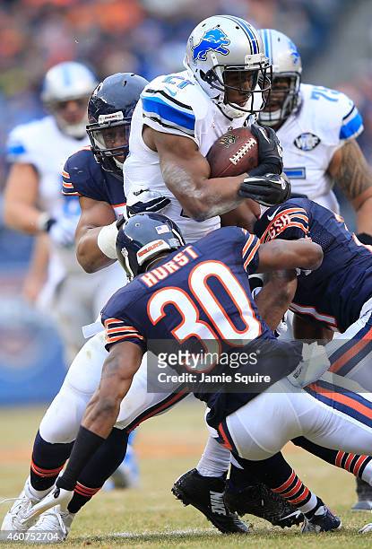 Reggie Bush of the Detroit Lions is tackled by Demontre Hurst of the Chicago Bears, Ryan Mundy and Jon Bostic during the second quarter at Soldier...