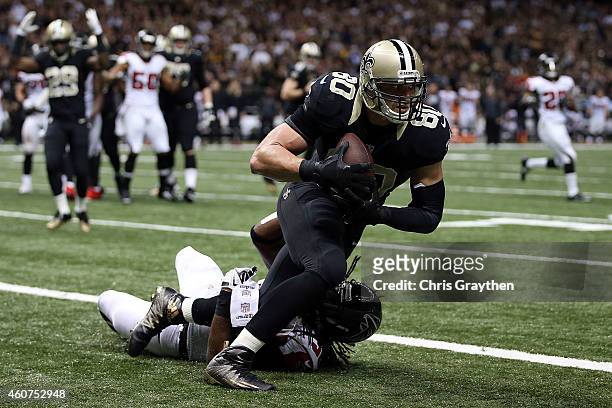 Jimmy Graham of the New Orleans Saints catches a touchdown pass in front of Kemal Ishmael of the Atlanta Falcons during the fourth quarter of a game...