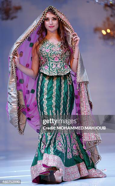 Model presents a creation by Bahraini fashion designer Kobrai al-Qoseer during the Gulf's Forum of Elegance event on December 21, 2014 in the Omani...