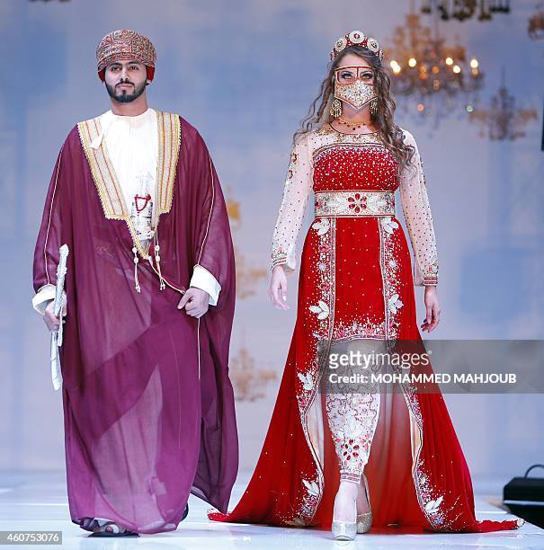 Models present creations by fashion designers Mohammed al-Sobhi and Amal al-Balushi during the Gulf's Forum of Elegance event on December 21, 2014 in...