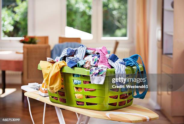 germany, north rhine westphalia, cologne, clothes in laundry basket - bügelbrett stock-fotos und bilder