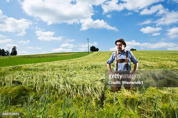 germany, bavaria, farmer standing in field - bauer bayern stock-fotos und bilder