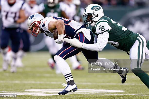 Wide receiver Danny Amendola of the New England Patriots is tackled by cornerback Antonio Allen of the New York Jets during a game at MetLife Stadium...