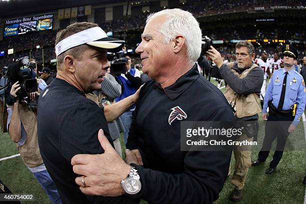 Head coach Mike Smith of the Atlanta Falcons and head coach Sean Payton of the New Orleans Saints meet at midfield following a game at the...