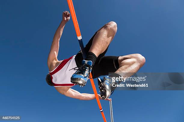 germany, mature man curling over high jump - hochsprung stock-fotos und bilder