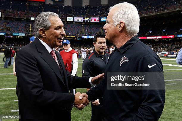 Head coach Mike Smith of the Atlanta Falcons meets with owner Arthur Blank following a game against the New Orleans Saints at the Mercedes-Benz...