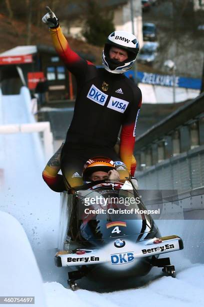 Martin Putze, Alexander Roediger, Marko Huebenbecker and Maximilian Arndt of Germany celebrate their victory after the second run of the four man bob...
