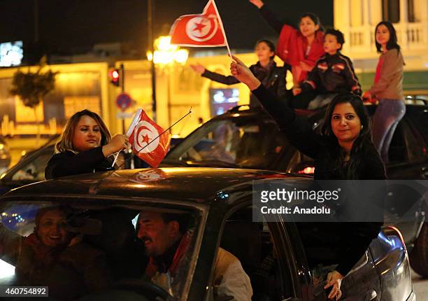 Supporters of Tunisian Nidaa Tounes Party chief and presidential candidate Beji Caid Essebsi celebrate after the first results following the second...