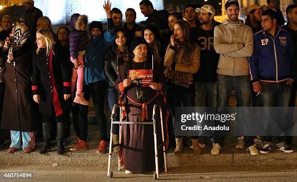 Supporters of Tunisian Nidaa Tounes Party chief and presidential candidate Beji Caid Essebsi celebrate after the first results following the second...