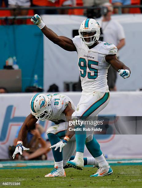 Defensive end Cameron Wake of the Miami Dolphins and defensive end Dion Jordan of the Miami Dolphins celebrate after a sack of quarterback Teddy...