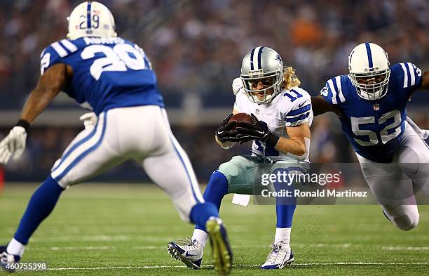 Cole Beasley of the Dallas Cowboys eludes D'Qwell Jackson of the Indianapolis Colts and Mike Adams of the Indianapolis Colts to score a touchdown in...