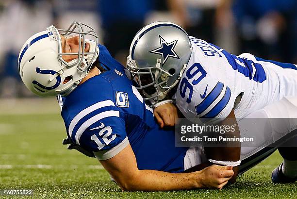 Andrew Luck of the Indianapolis Colts is hit by George Selvie of the Dallas Cowboys in the first half at AT&T Stadium on December 21, 2014 in...
