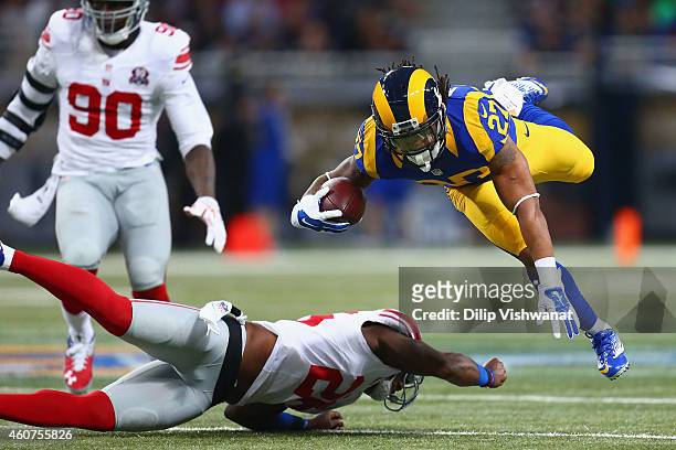 Tre Mason of the St. Louis Rams is tackled by Antrel Rolle of the New York Giants during the first quarter at the Edward Jones Dome on December 21,...