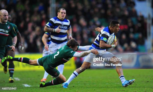 Bath wing Anthony Watson escapes the clutches of Tigers player Toby Flood during the Aviva Premiership match between Leicester Tigers and Bath at...