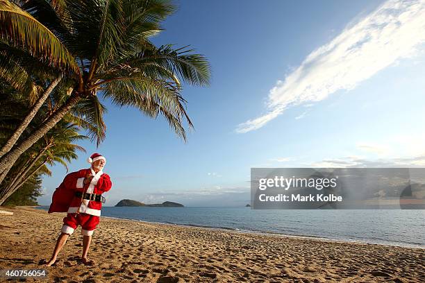 Christmas in paradise.Santa chills out at one of Queensland, Australias tropical beaches before the big night. Queensland's beaches rank amongst the...