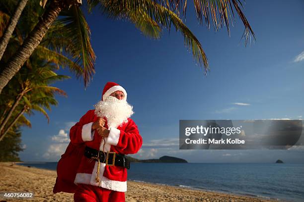 Christmas in paradise.Santa chills out at one of Queensland, Australias tropical beaches before the big night. Queensland's beaches rank amongst the...